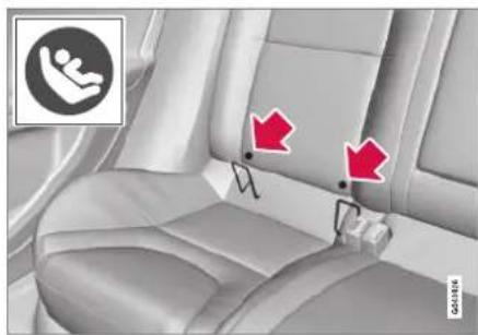 Interior view of a car seat with two red arrows pointing to the seat area, no text or symbols present.
