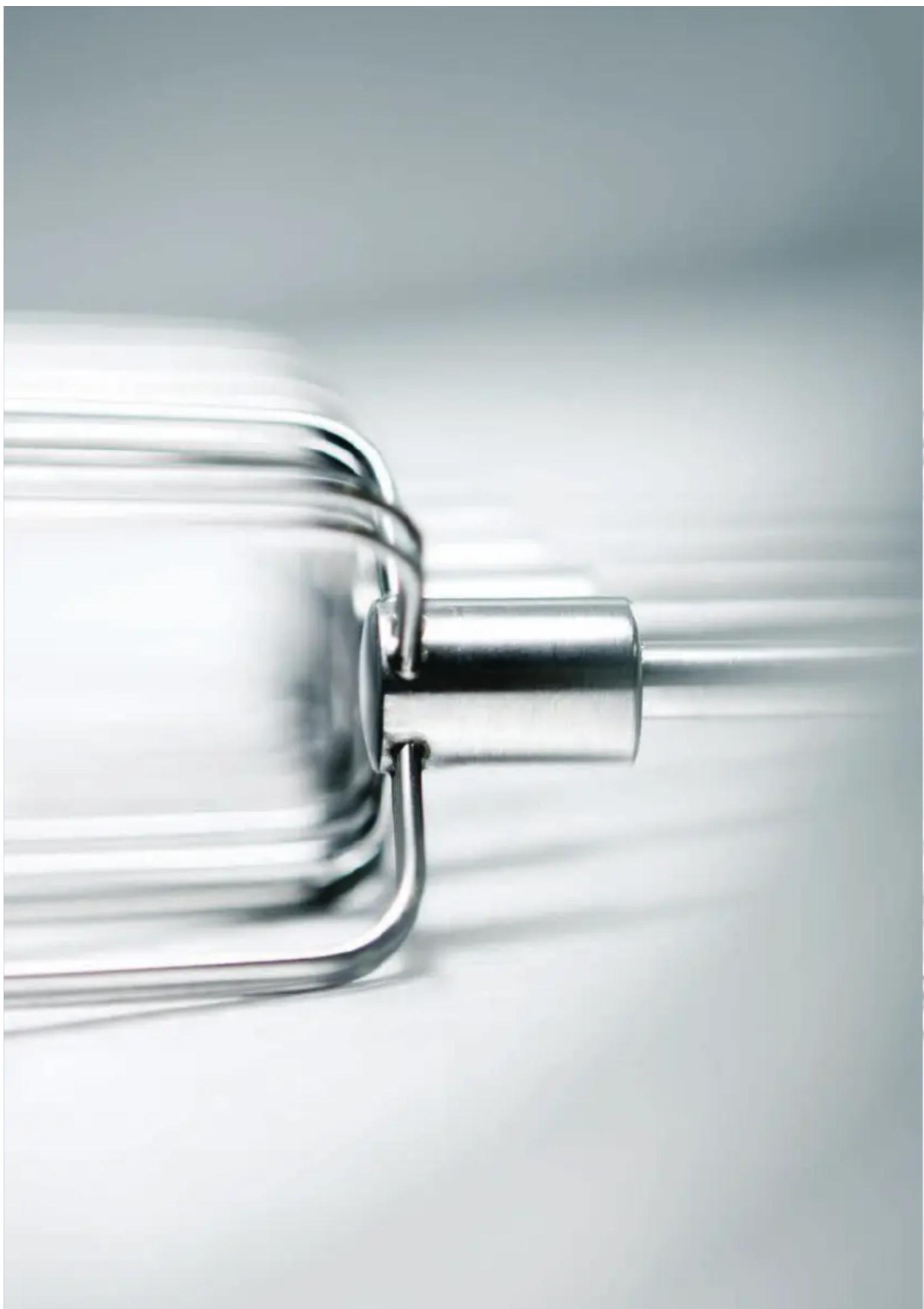 Close-up of a metallic mechanical component with a cylindrical shaft and flanged end (no text or symbols visible)