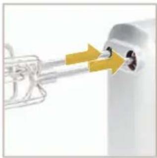 Close-up of a white industrial component with a yellow arrow pointing to a small black hole (no text or symbols visible)