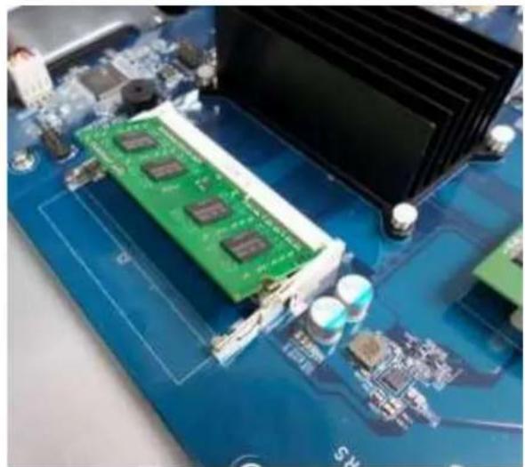 Close-up of a green circuit board with a card and cooling unit, no visible text or symbols