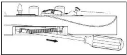 Diagram of a mechanical device with a tool inserted into a housing, showing internal components and motion direction (no text or symbols)