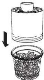Diagram showing a cylindrical container being inserted into a granular material, with an arrow indicating the process (no text or symbols present)