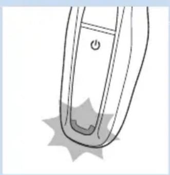 Line drawing of a handheld device with a power button and star-shaped base (no text or symbols)