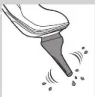 Illustration of a brush tip emitting small particles (no text or symbols)