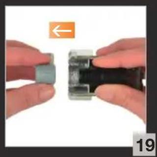 Close-up of hands holding a small mechanical component, no visible text or symbols