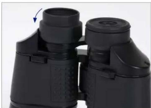 Close-up of black binoculars with a blue arrow indicating rotation (no text or symbols visible)