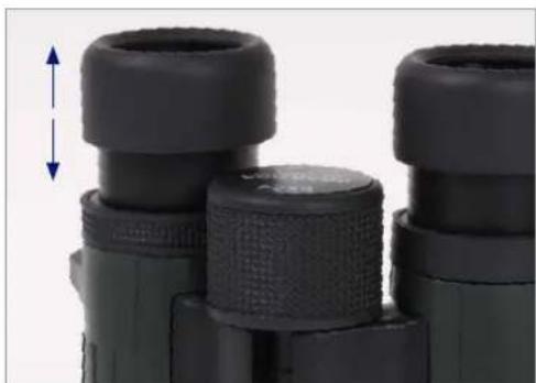Close-up of binoculars with black caps and textured grip, no visible text or symbols