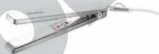 Close-up of a metallic mechanical device with wires and a small component, no visible text or symbols.