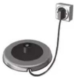 Close-up of a circular mechanical component connected to a wall-mounted power outlet (no text or symbols visible)