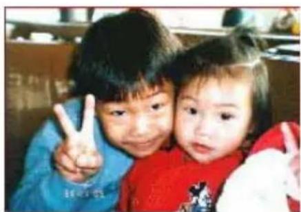 Two children making peace signs together, one smiling and the other looking upward (no visible text or symbols)