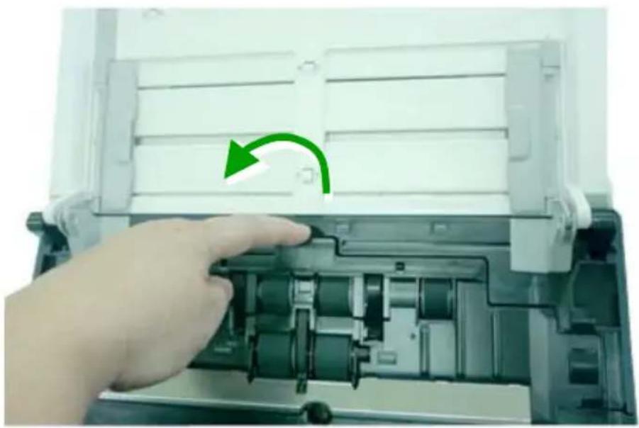 Hand inserting a device into an open plastic enclosure with a green circular arrow indicating rotation (no text or symbols visible)