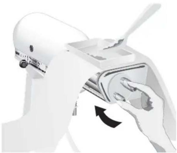 Illustration of a hand using a sewing machine to adjust the blade (no text or symbols visible)