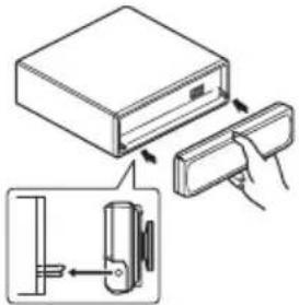 Diagram showing a device being inserted into a box, with an inset close-up illustrating the internal structure.