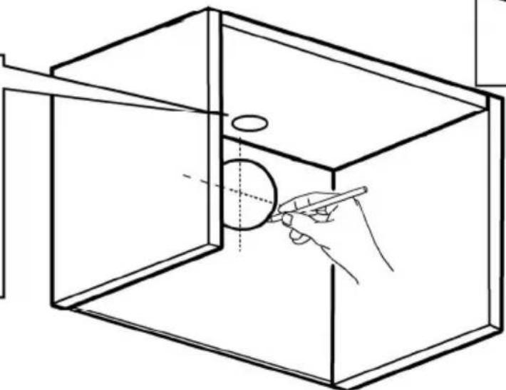 Line drawing of a hand holding a pen inside a transparent cube containing a circular hole, with no text or symbols present.