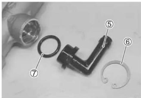 Labeled diagram of a mechanical component with numbered parts, likely for assembly or repair reference.