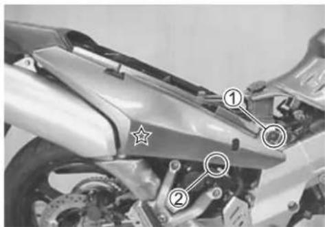 Labeled mechanical component diagram showing parts numbered 1 and 2 with star marker and circular features