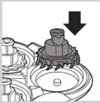 Mechanical assembly diagram showing a gear-like component with a downward arrow indicating motion (no text or symbols present)