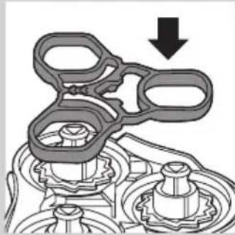 Mechanical assembly diagram showing gear and shaft components with a downward arrow indicating motion (no text or symbols)