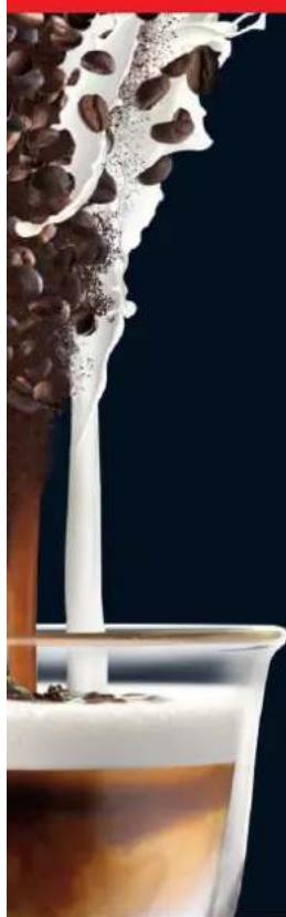 Close-up of a dessert with whipped cream being poured into a glass of coffee against a black background (no text or symbols visible)