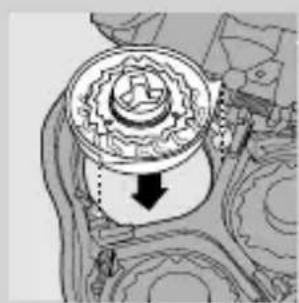 Mechanical gear assembly diagram showing a rotating component with a downward arrow indicating motion (no text or labels)