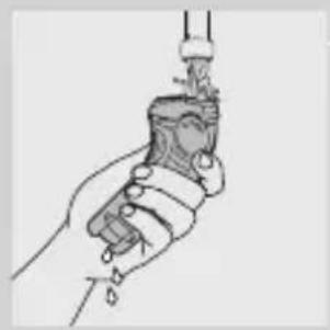 Line drawing of a hand holding a handheld device with a plug inserted (no text or symbols)