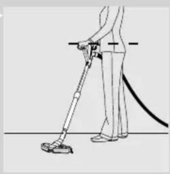 Line drawing of a person using a handheld vacuum cleaner (no text or symbols).