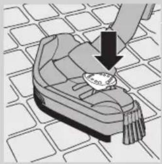 Illustration of a hand placing a plate with a down arrow on a patterned surface.