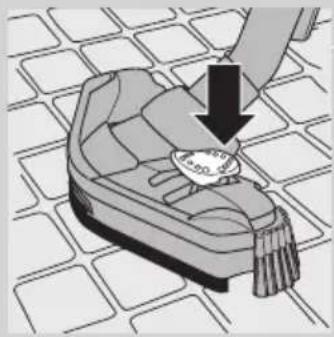 Illustration of a hand holding a small object over a patterned surface, with no visible text or symbols.