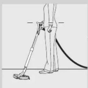 Line drawing of a person using a handheld vacuum cleaner to lift a surface (no text or symbols)