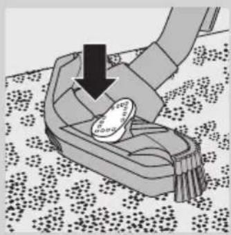 Illustration of a hand pressing down on a small object on a patterned floor (no text or symbols)