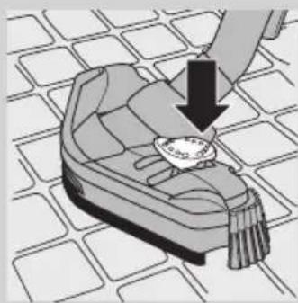 Illustration of a hand holding a small object over a patterned surface. No visible text or symbols.