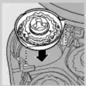 Mechanical gear assembly diagram showing a rotating component with a downward arrow indicating motion (no text or labels)