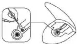Diagram showing a hand holding a small object inside a device, with an open lid view (no text or symbols)