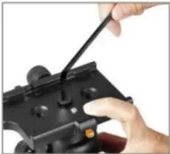 Close-up of a hand using a black tool to adjust a black game controller (no text or symbols visible)