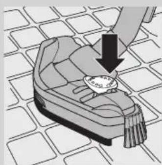 Illustration of a hand holding a small object on a patterned surface, with no visible text or symbols.