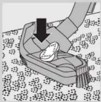 Illustration of a hand pressing down on a small object with a downward arrow, placed on a patterned surface (no text or symbols).
