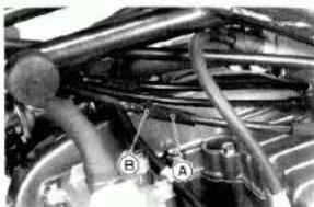 Close-up of a mechanical engine with hoses and components (no visible text or symbols)