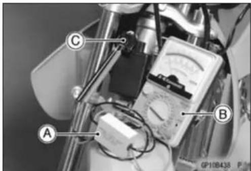 Labeled mechanical device setup with components A, B, and C, showing wiring and a multimeter.