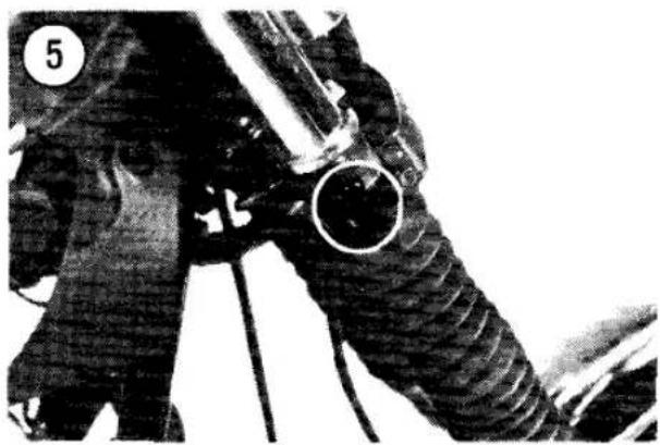 Close-up of a mechanical component with a circular hole and textured body, possibly a valve or hose (no visible text or symbols)
