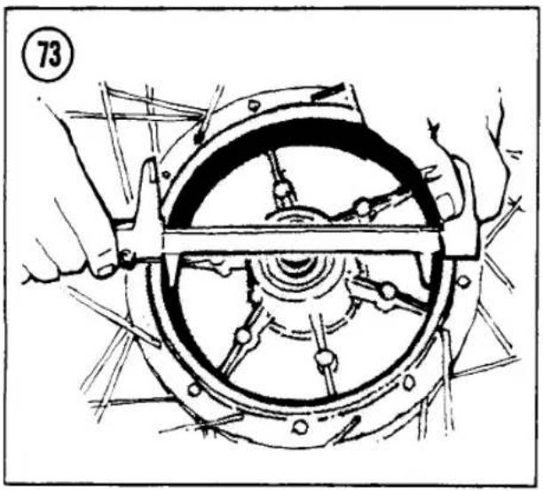 Technical line drawing of a mechanical assembly with hands operating a wheel (no text or symbols)