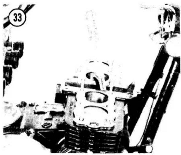Black-and-white photo of a mechanical engine assembly with visible gears and shafts (no text or symbols)