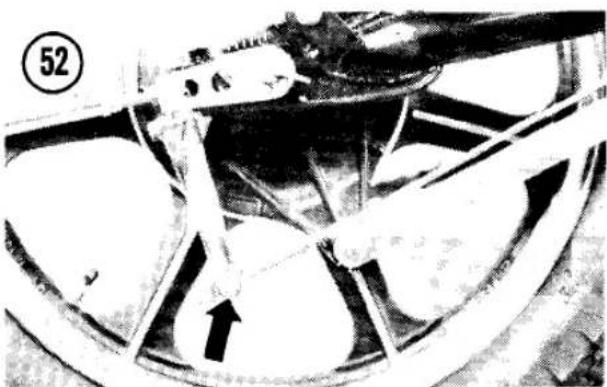 Close-up of a car wheel rim with visible mechanical components and a numbered marker (52) in the corner, no readable text or symbols.