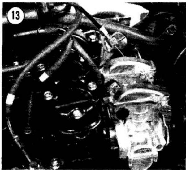 Close-up of a mechanical engine assembly with hoses and components (no visible text or symbols)