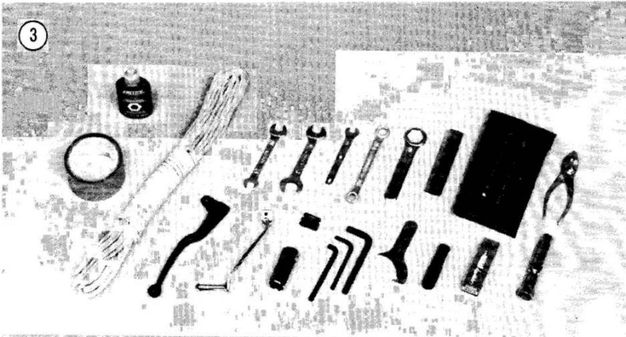 Assorted hand tools including wrenches, pliers, and a cleaver on a workbench (no text or symbols visible)