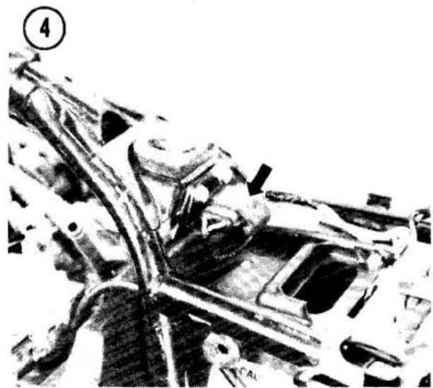 Mechanical assembly diagram showing a component with an arrow pointing to a specific part (no text or symbols present)