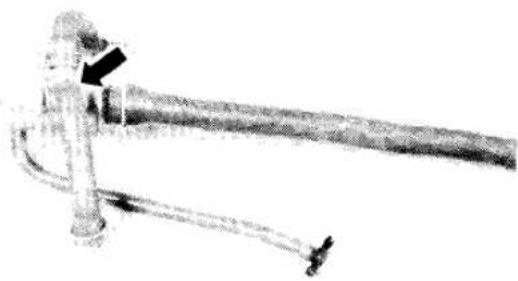 Mechanical device with a cylindrical shaft and attached tubing, no visible text or symbols