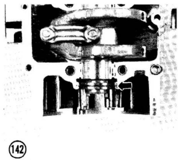 Mechanical assembly diagram showing internal components and a directional arrow (no text or labels)