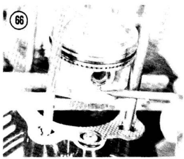 Close-up of a piston head assembly with visible mechanical components (no text or symbols)