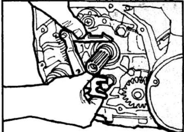 Mechanical assembly diagram showing hands operating a gear and shaft (no text or labels)