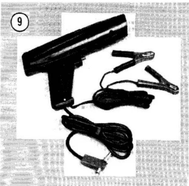Black handheld electronic device with coiled wires and connectors, no visible text or symbols